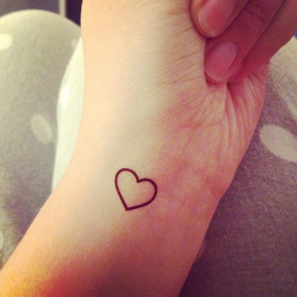 Black outline Heart Tattoo On Wrist