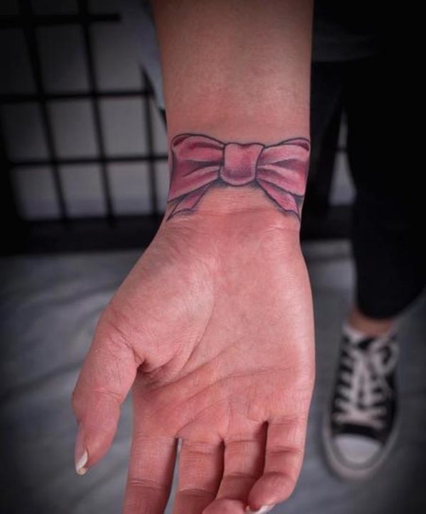 Pink Bow Tattoo On Wrist