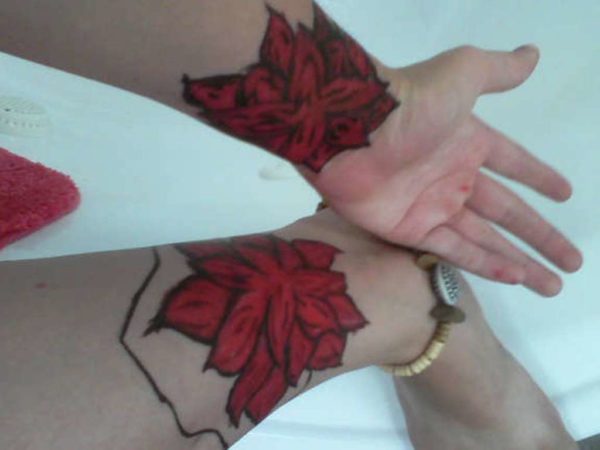 Red Flower Tattoo On Wrist