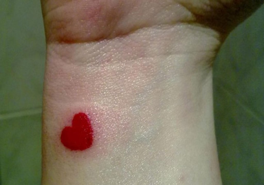 Red Small Heart Tattoo On Wrist.