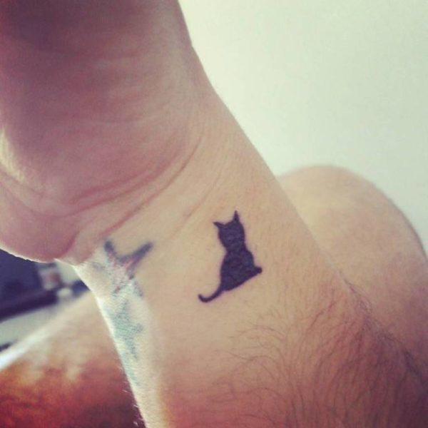 Tiny Black  Cat Tattoo On Wrist