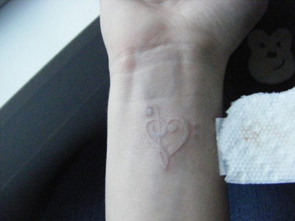 Whit Ink Music Heart Tattoo On Wrist