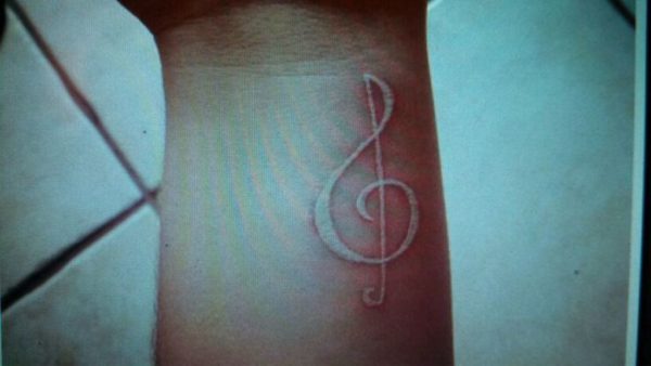 White Ink Musical Tattoo On Wrist