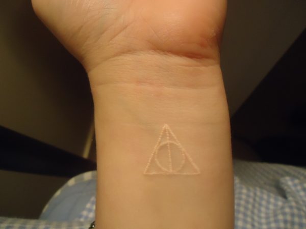 White Ink Wrist Tattoo 