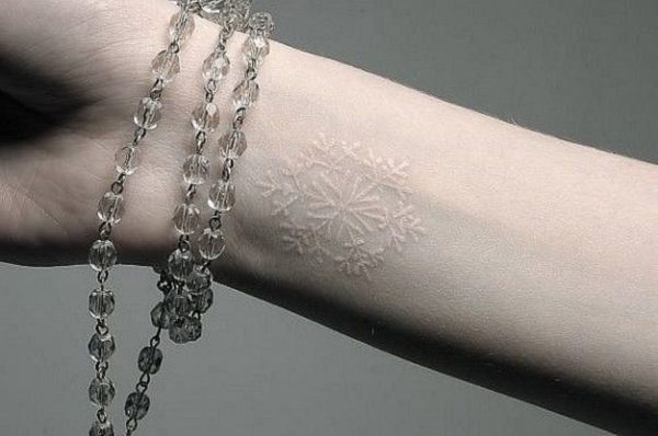 White Snowflake Tattoo On Wrist