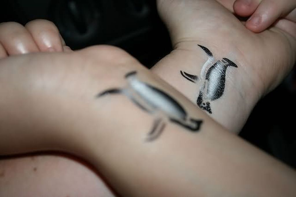 Adorable Wrist Penguin Tattoo