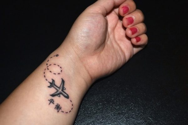 Black Airplane Tattoo On Wrist