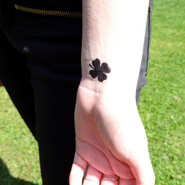 Black Four Leaf Tattoo On Wrist