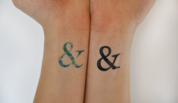 Colored And Black Ampersand Wrist Tattoo