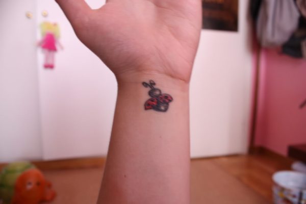 Cute Flying Ladybug Wrist Tattoo