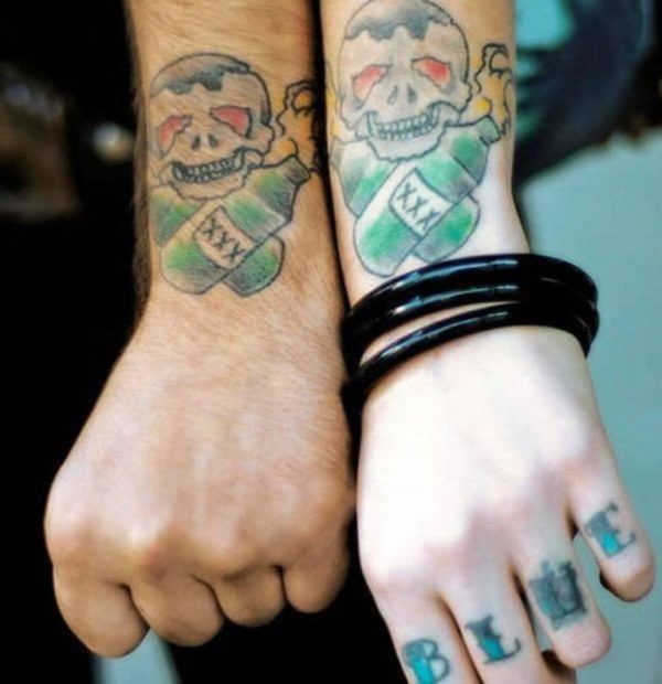 Cute Matching Skull And Bottle Tattoos On Wrist
