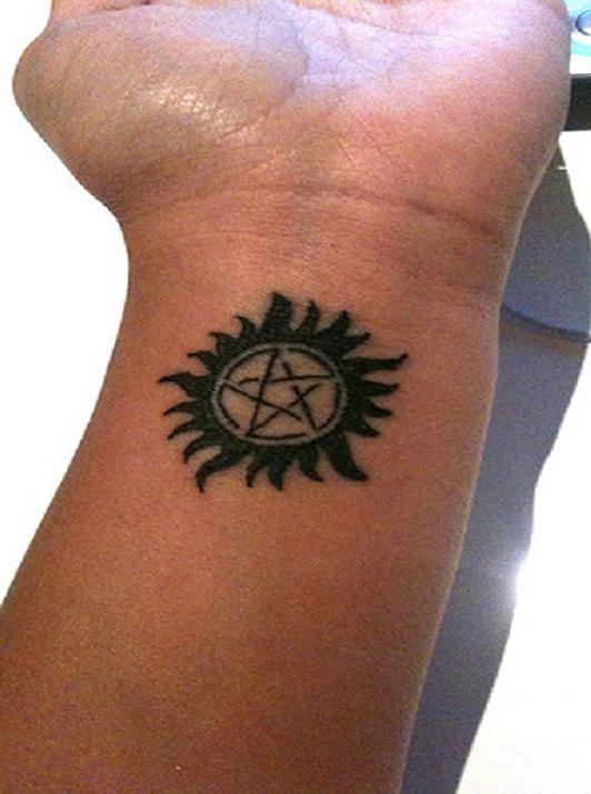 Impressive Sun Star Tattoo On Wrist