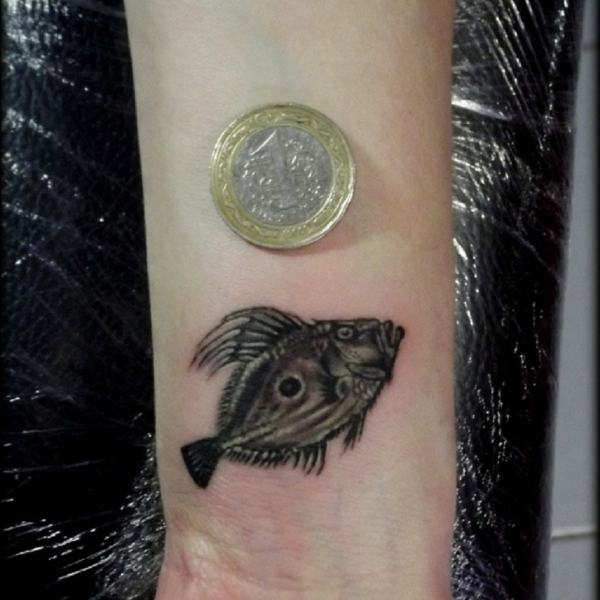 Little Black Fish Tattoo On Wrist