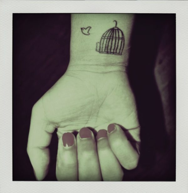 Nice Flying Bird And Cage Tattoo On Wrist