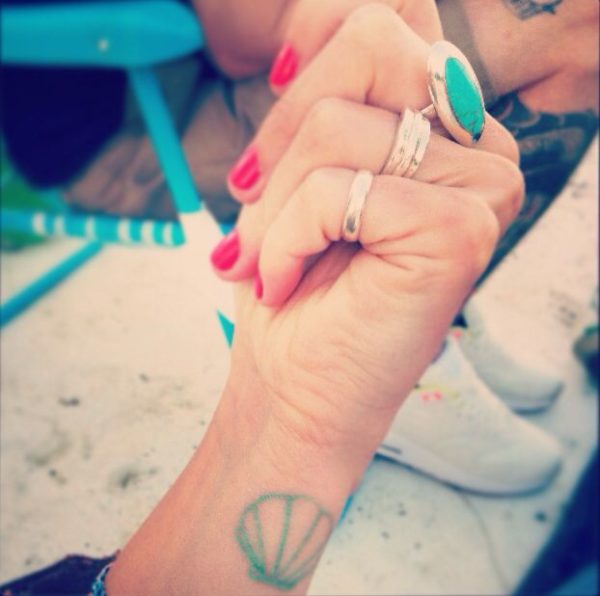 Nice Green Seashell Tattoo On Wrist