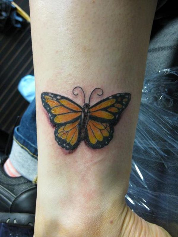 Nice Yellow Butterfly Tattoo On Wrist