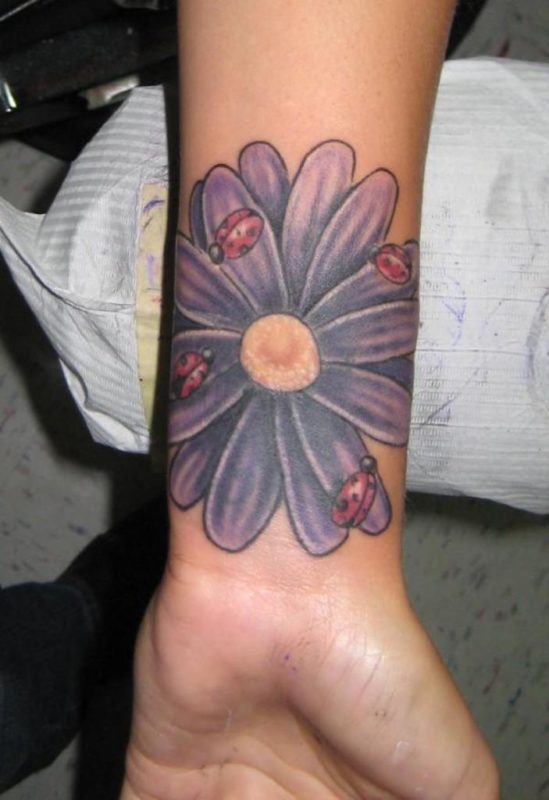 Purple Daisy Flower With Ladybugs Tattoo On Wrist