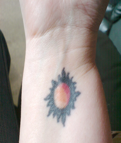 Simple Colored Sun Tattoo On Wrist