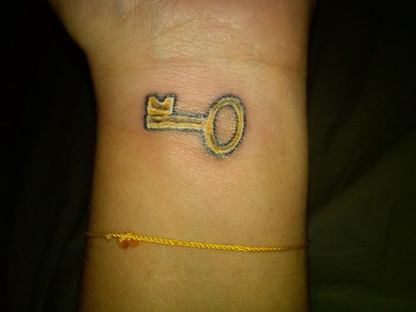 Small Yellow Key Tattoo For Wrist