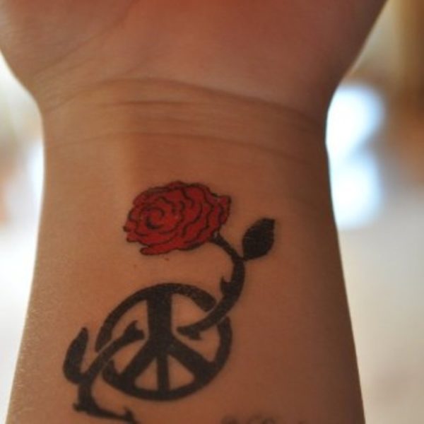 Wheel And Rose Tattoo On Wrist