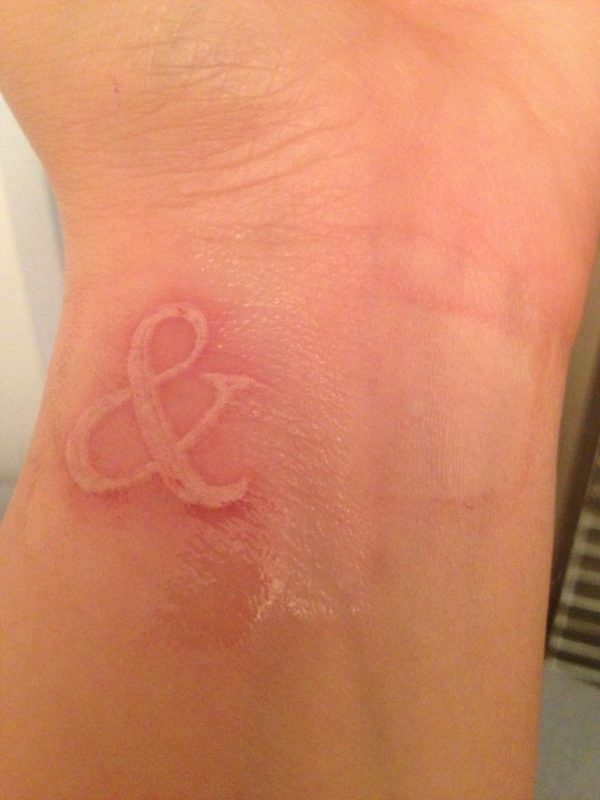 White Ampersand Tattoo On Wrist