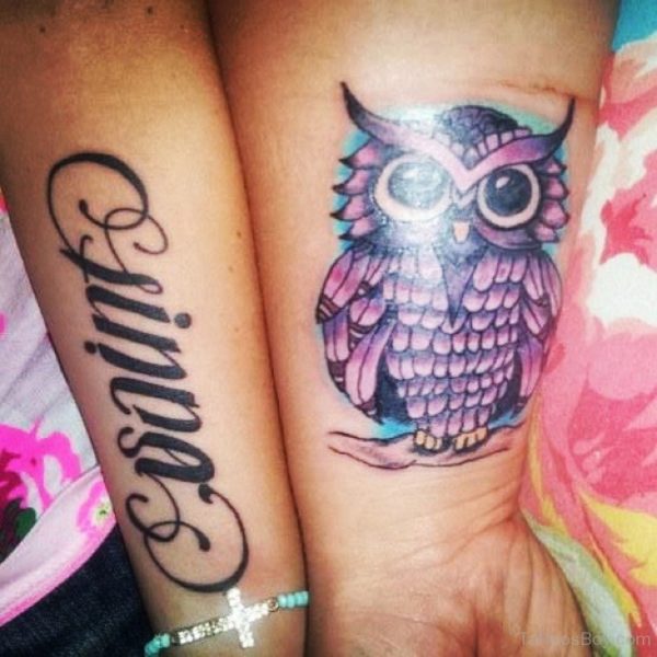 Wording And Owl Tattoo On Wrist