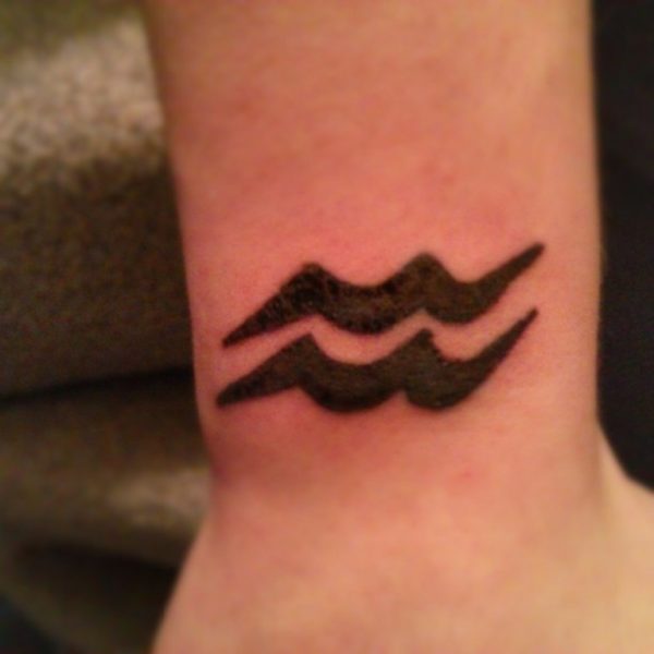 Black Aquarius Tattoo On Wrist