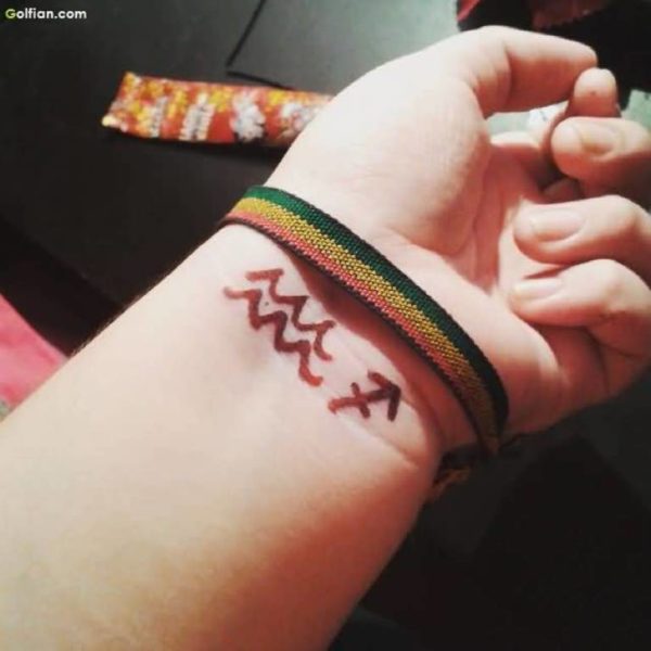 Brown Aquarius Tattoo On Wrist
